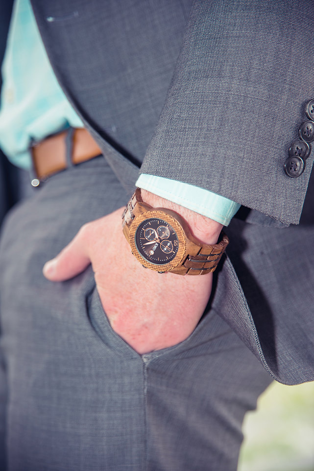man wearing jord conway series walnut jet black unique wood watch joseph aboud gray suit hand in pocket closeup